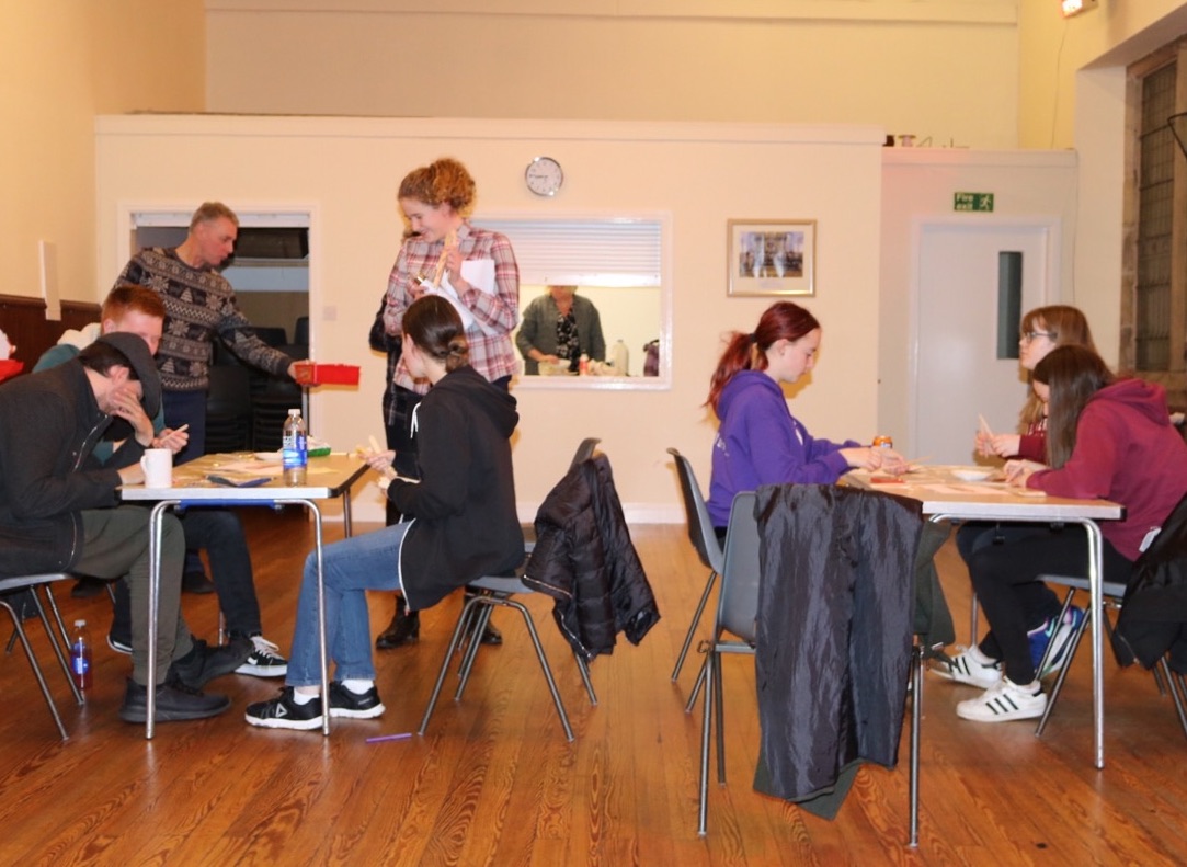 youth group lower hall at tables in front of hatch cropped copy 2